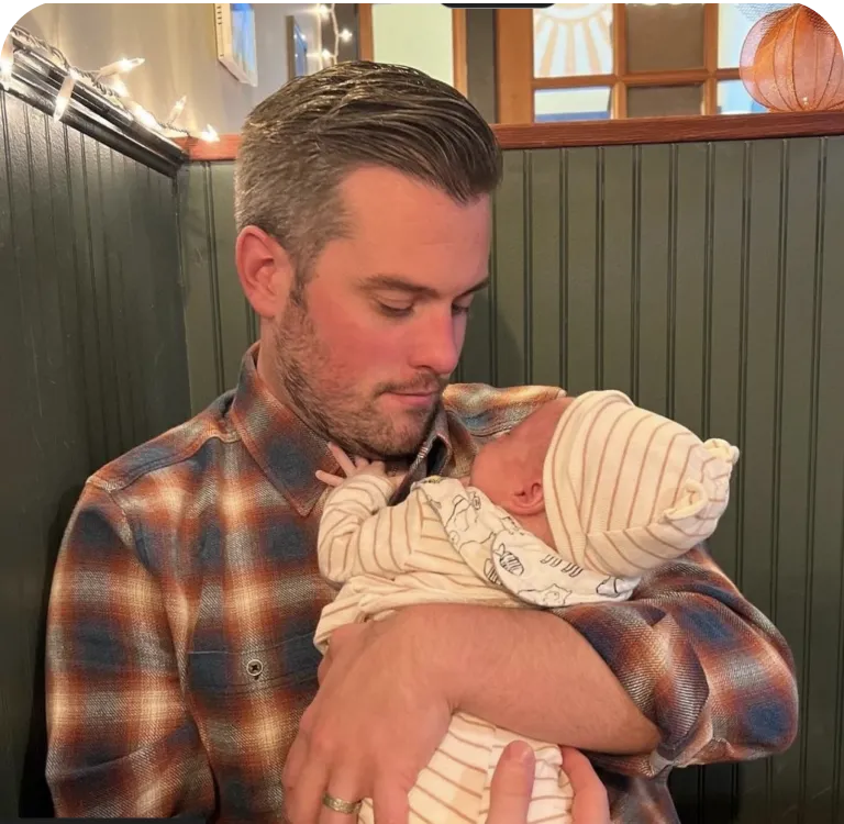 Father holding a swaddled newborn