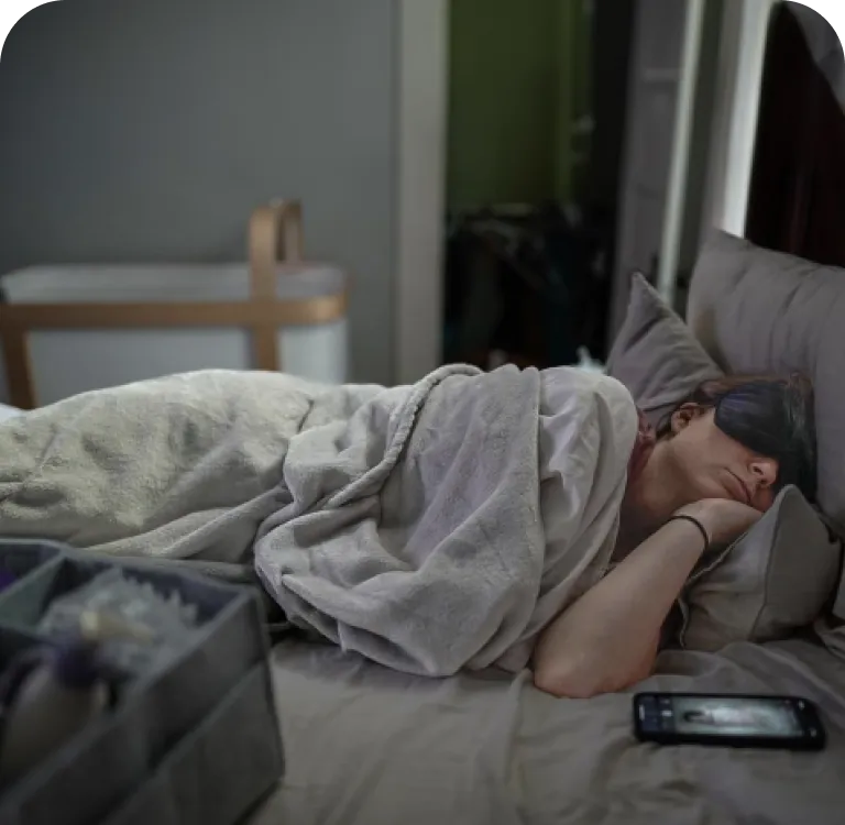 Mother napping beside the crib