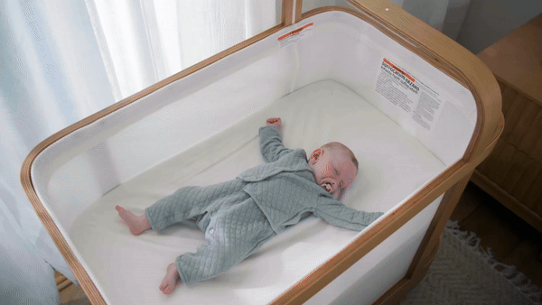 An animated series of images showing a baby during the quiet phase of sleep in a Cradlewise crib, with the Cradlewise crib automatically bouncing and soothing the baby, while the Cradlewise app monitors and adjusts settings to support the baby’s sleep.