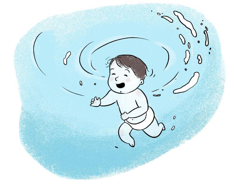 A baby playing in water