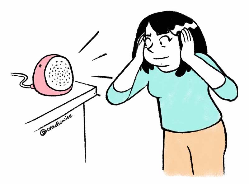 A woman shutting her ears because of the loud noise of the white noise machine